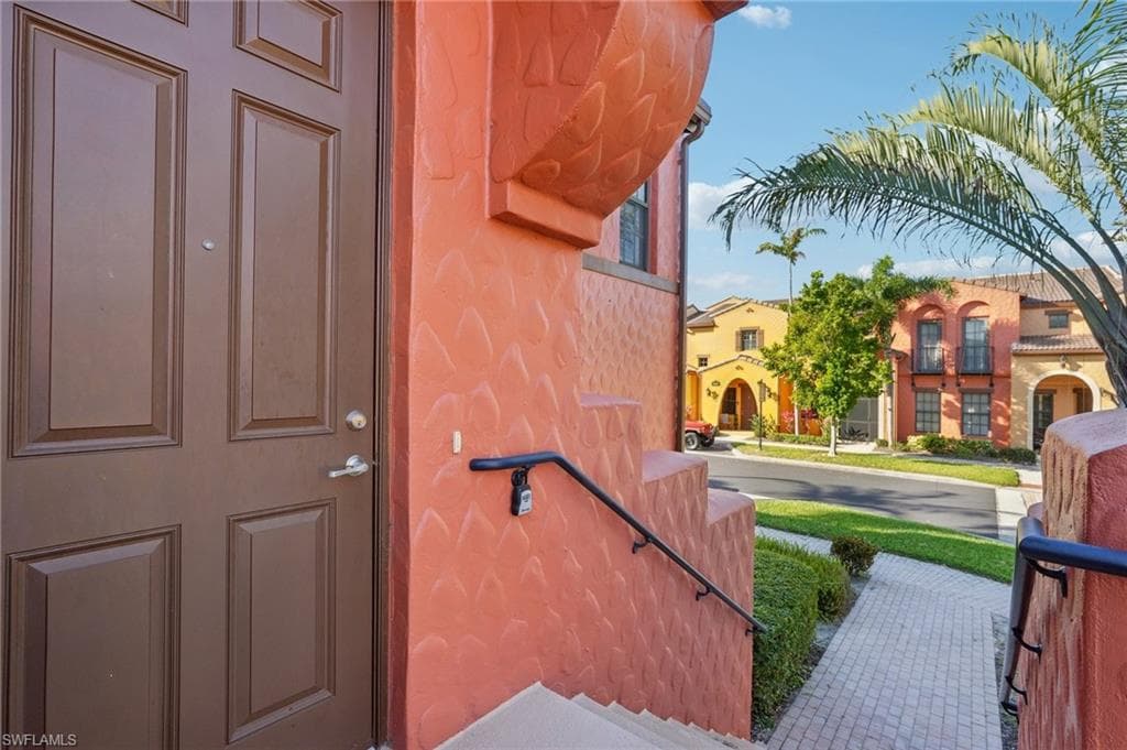 Doorway to property featuring stucco siding
