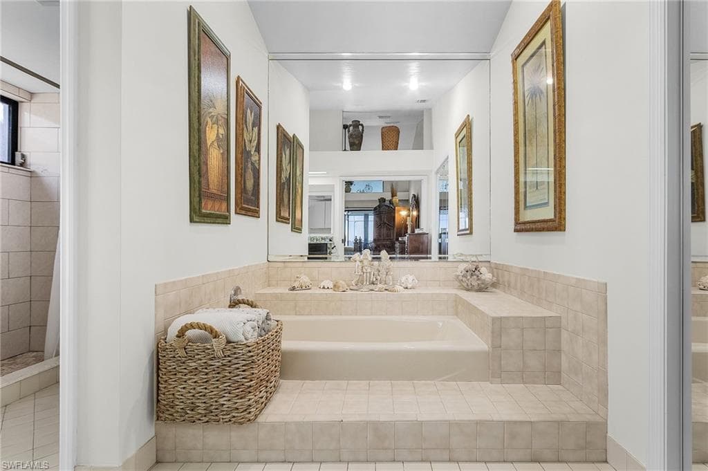 Primary ensuite Bathroom downstairs with soaking tub, water closet with walk in shower, large walk in closet
