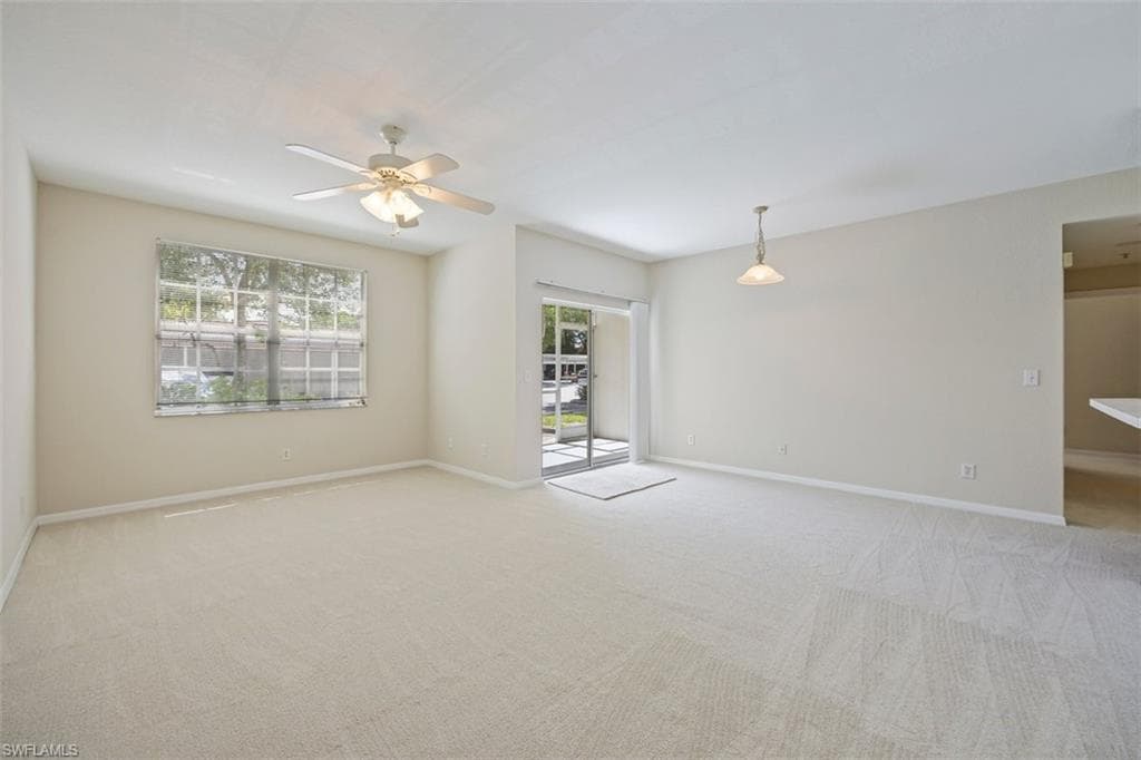 Unfurnished room featuring a ceiling fan and light carpet