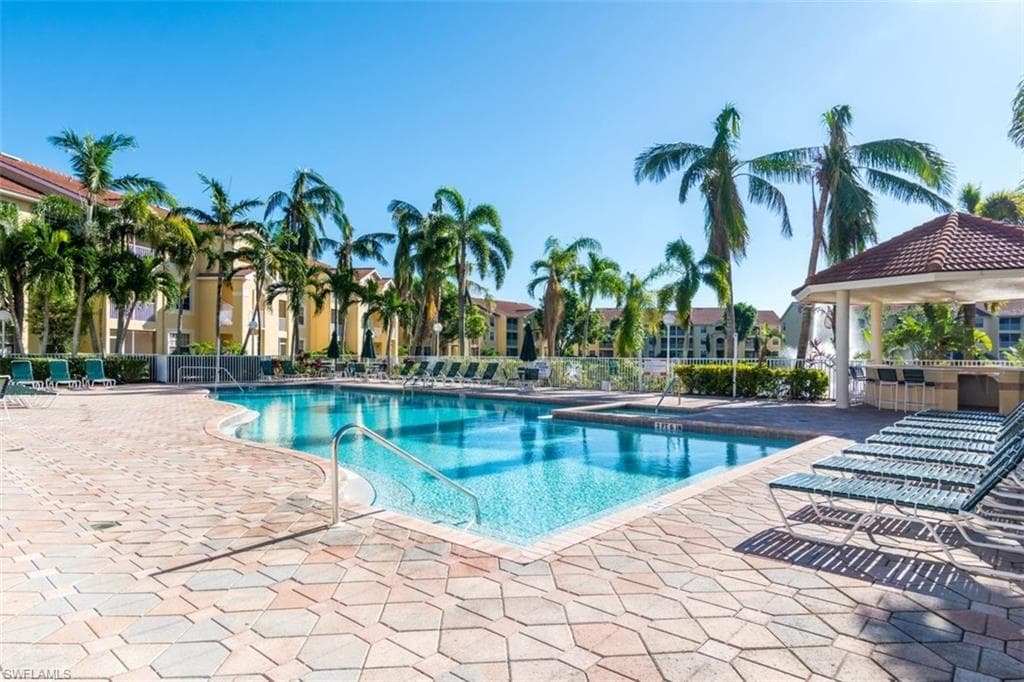 Community pool with a patio