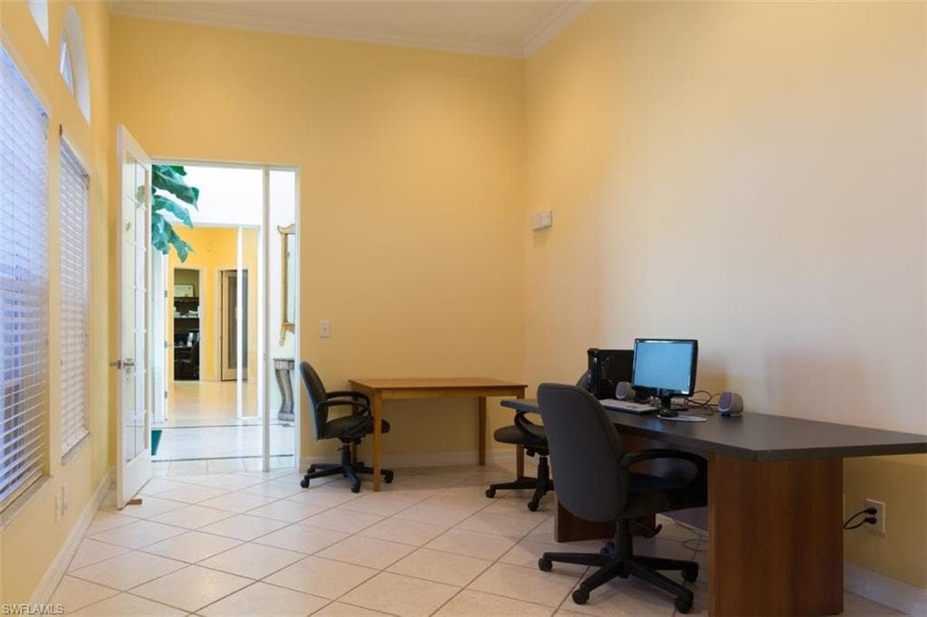 Home office featuring ornamental molding and light tile patterned flooring