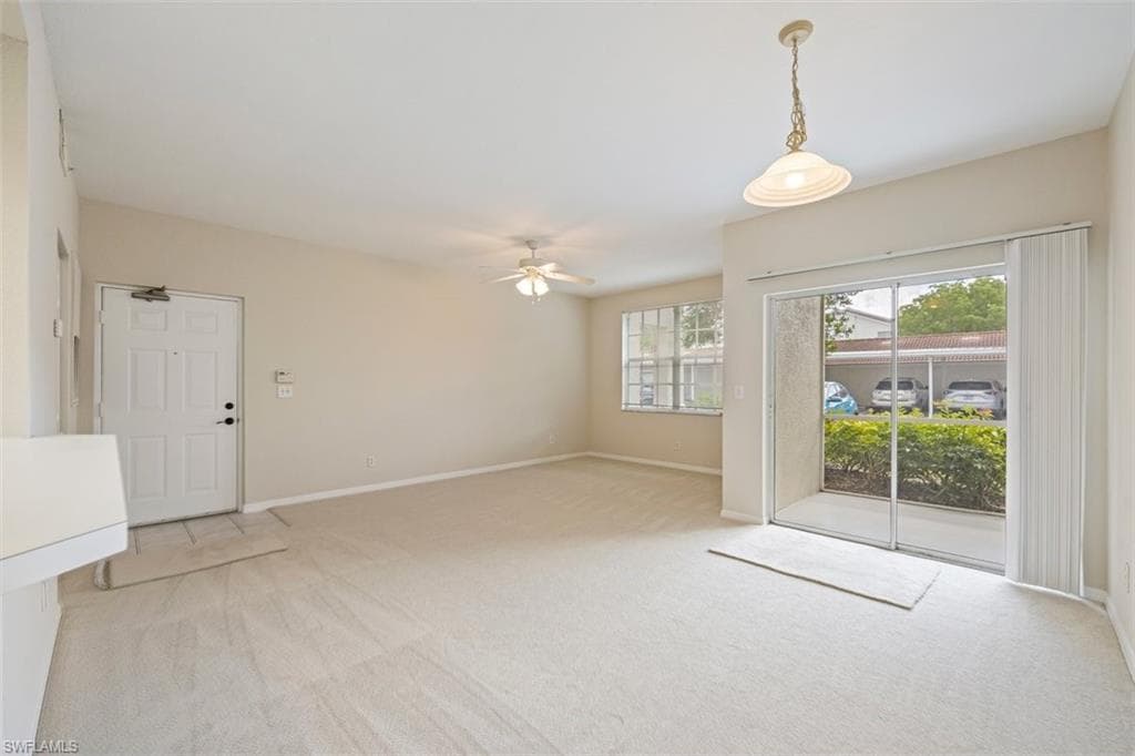 Spare room with light carpet and ceiling fan
