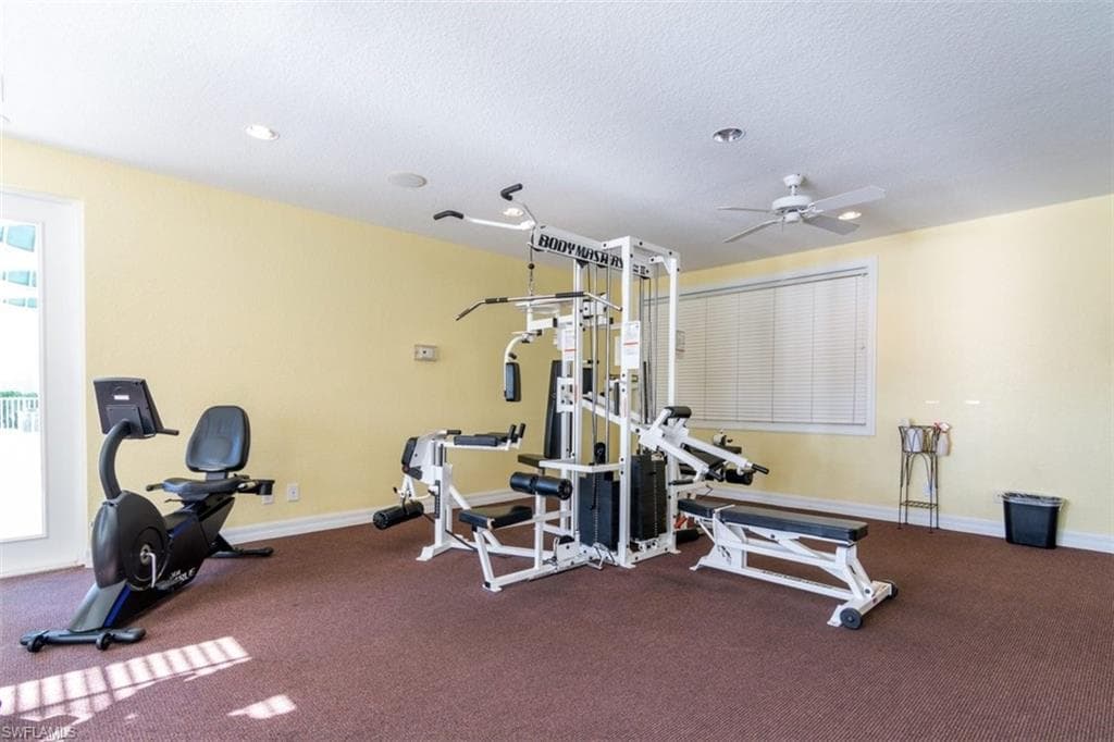 Workout area featuring a textured ceiling, a ceiling fan, plenty of natural light, and recessed lighting