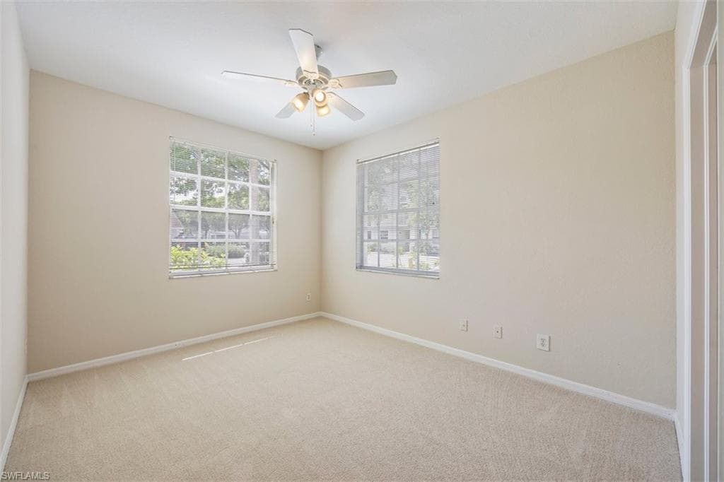 Unfurnished room with carpet floors and a ceiling fan