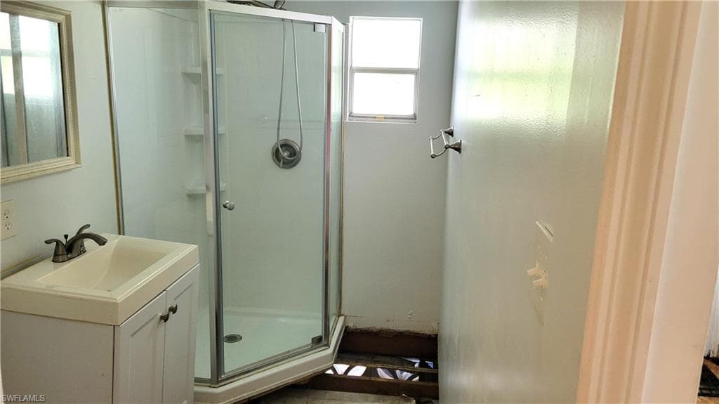 Bathroom featuring a stall shower and vanity