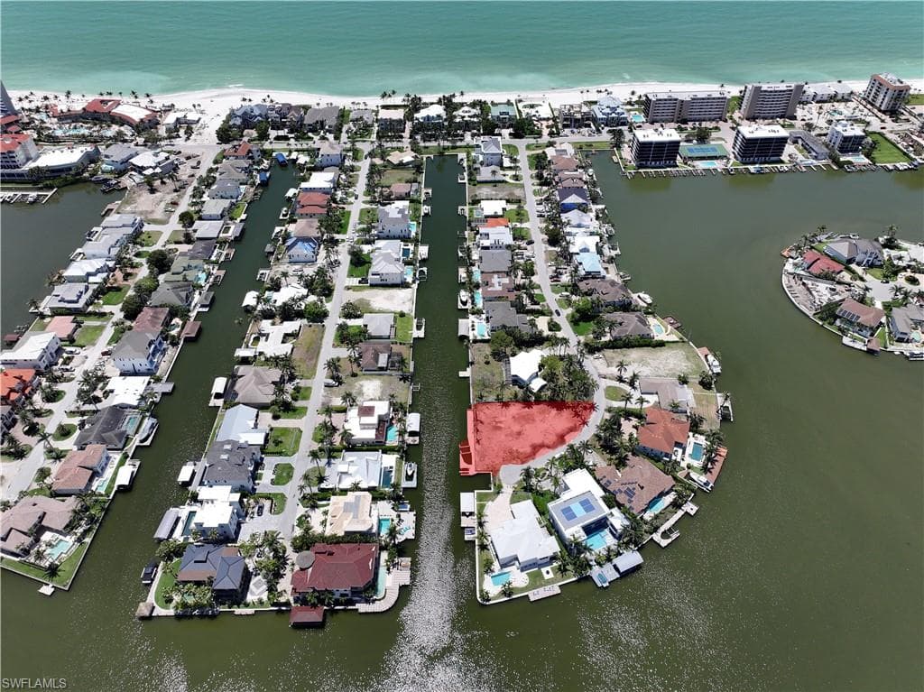 View of property location featuring a large body of water and nearby suburban area