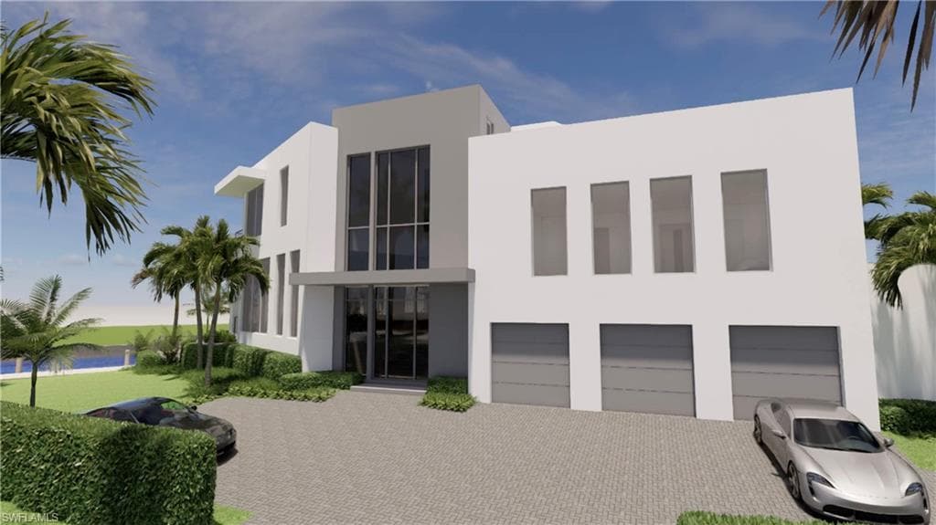 View of front of home featuring stucco siding, an attached garage, and decorative driveway