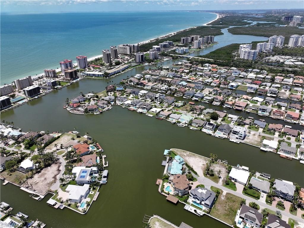 View of property location with a nearby body of water and nearby suburban area