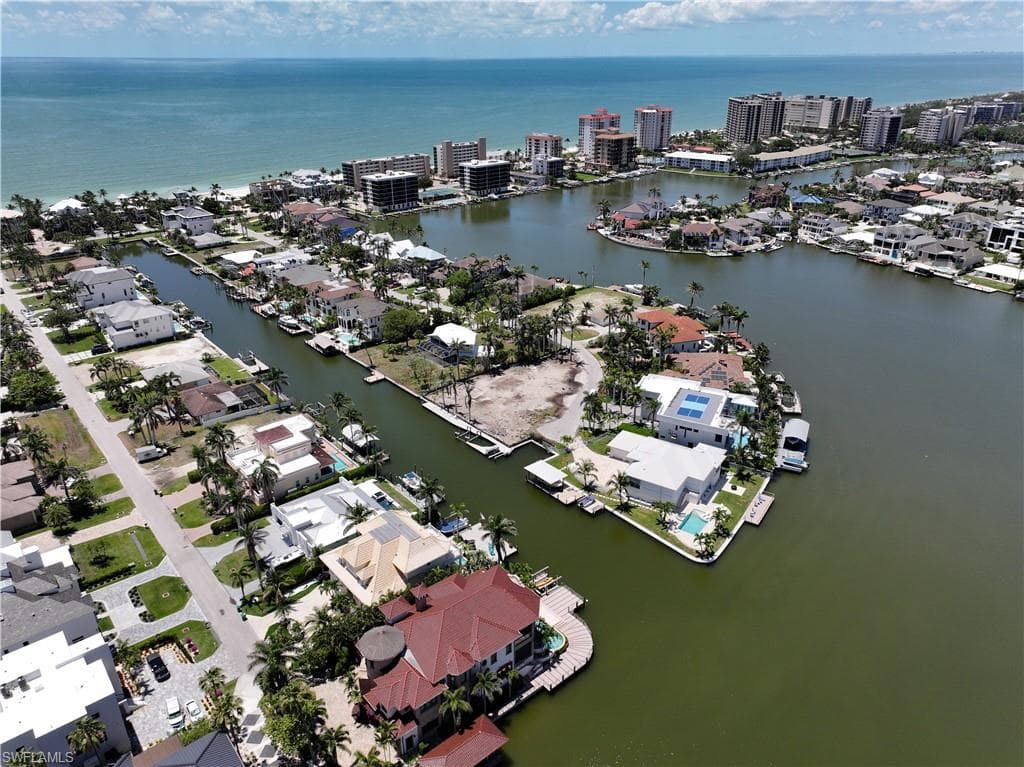 Aerial view of residential area featuring a nearby body of water
