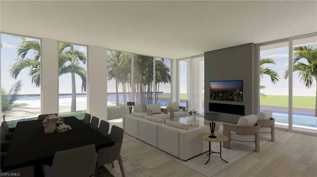 Living room featuring floor to ceiling windows, light wood-style flooring, and plenty of natural light