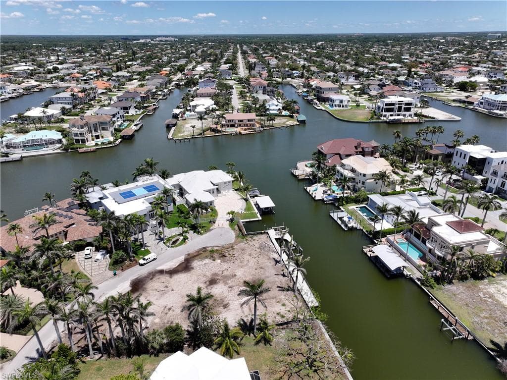 Aerial perspective of suburban area featuring a nearby body of water