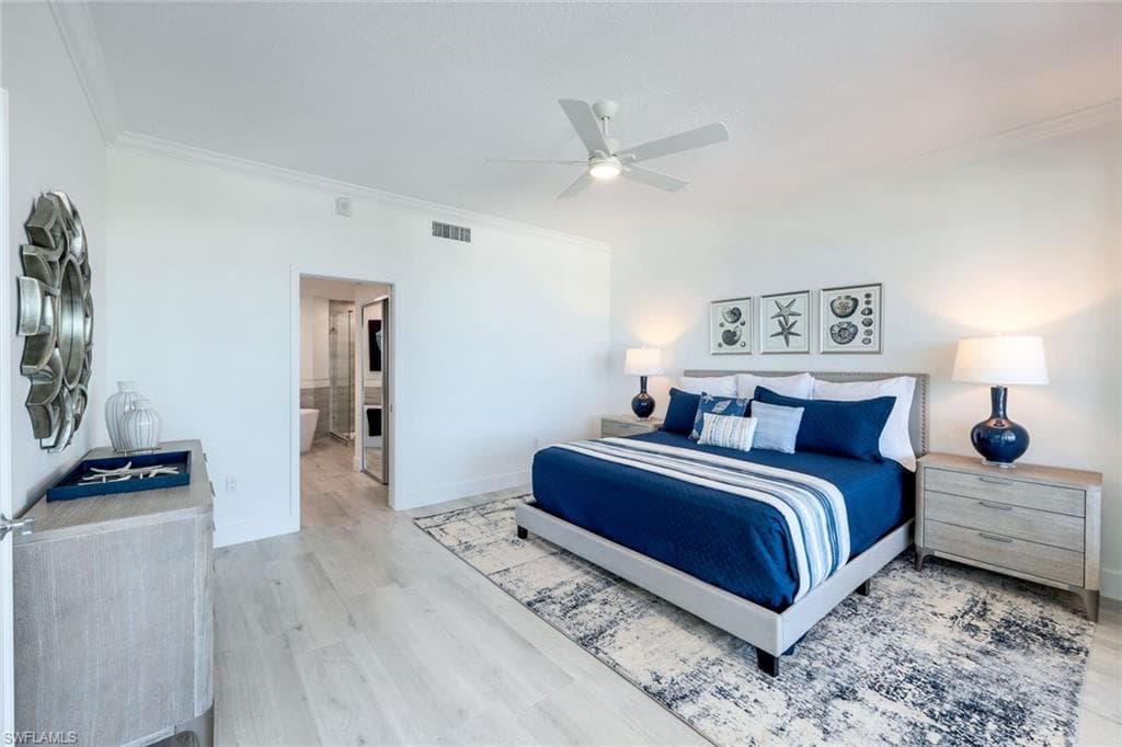 Bedroom featuring ornamental molding, wood finished floors, baseboards, a ceiling fan, and connected bathroom
