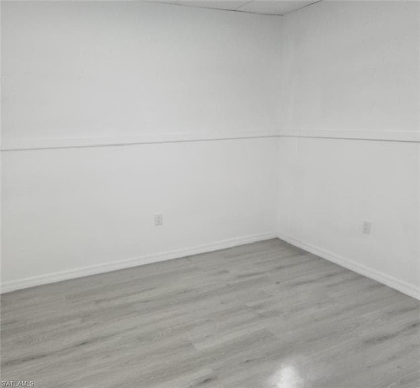 Unfurnished room with baseboards and wood finished floors