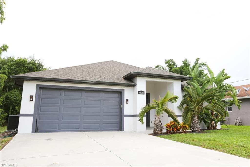 View of front of property with stucco siding, concrete driveway, a shingled roof, an attached garage, and central air condition unit