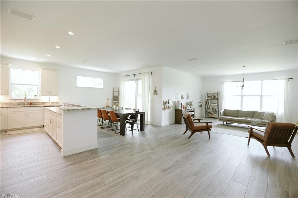 Living room featuring light wood-type flooring and recessed lighting