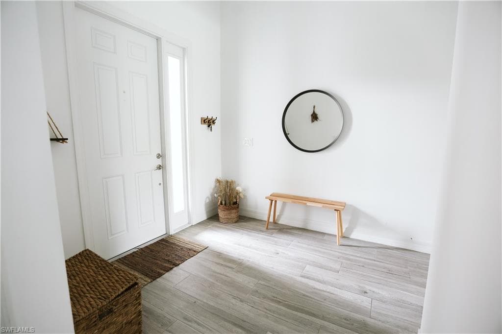 Foyer featuring wood finished floors and baseboards