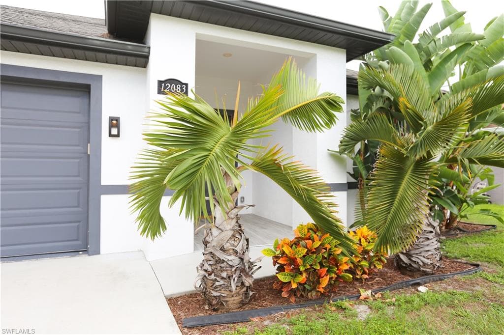 Property entrance featuring stucco siding