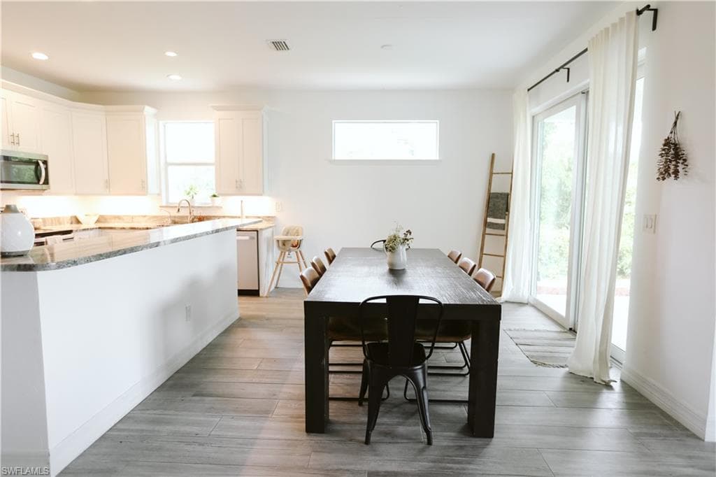 Dining space featuring plenty of natural light, recessed lighting, and light wood-style flooring