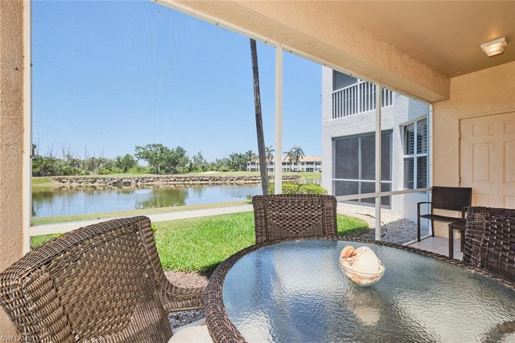 View of patio with a water view and outdoor dining area