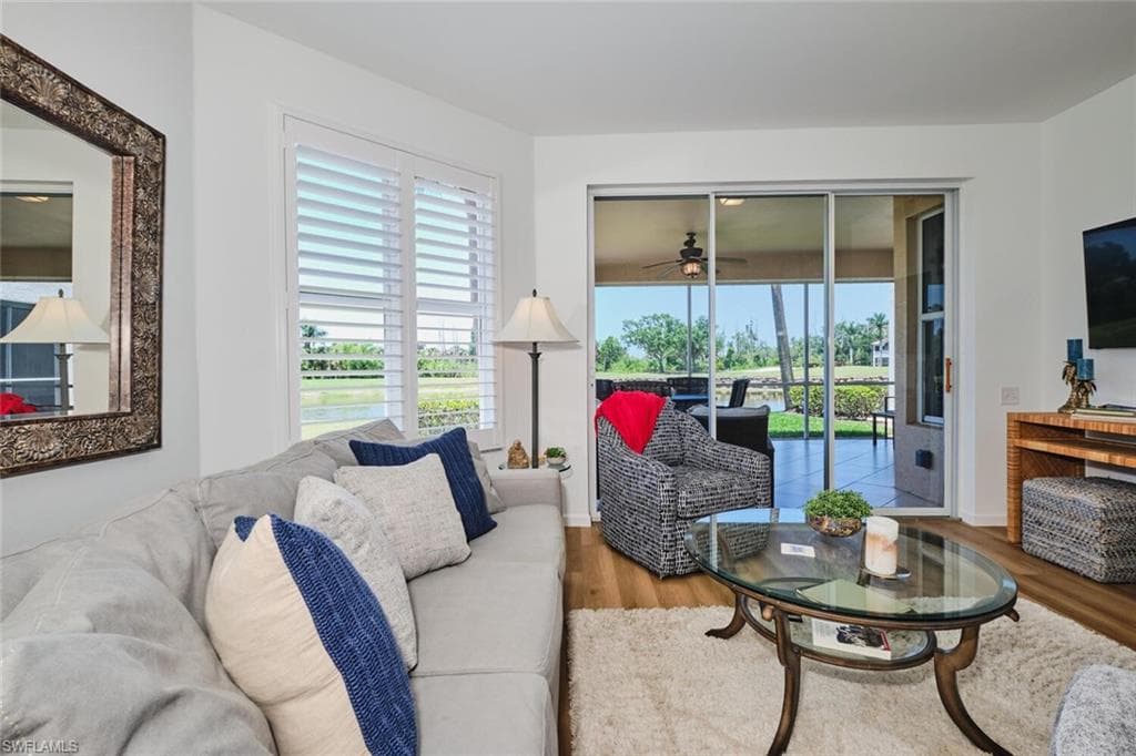 Living area with wood finished floors and ceiling fan