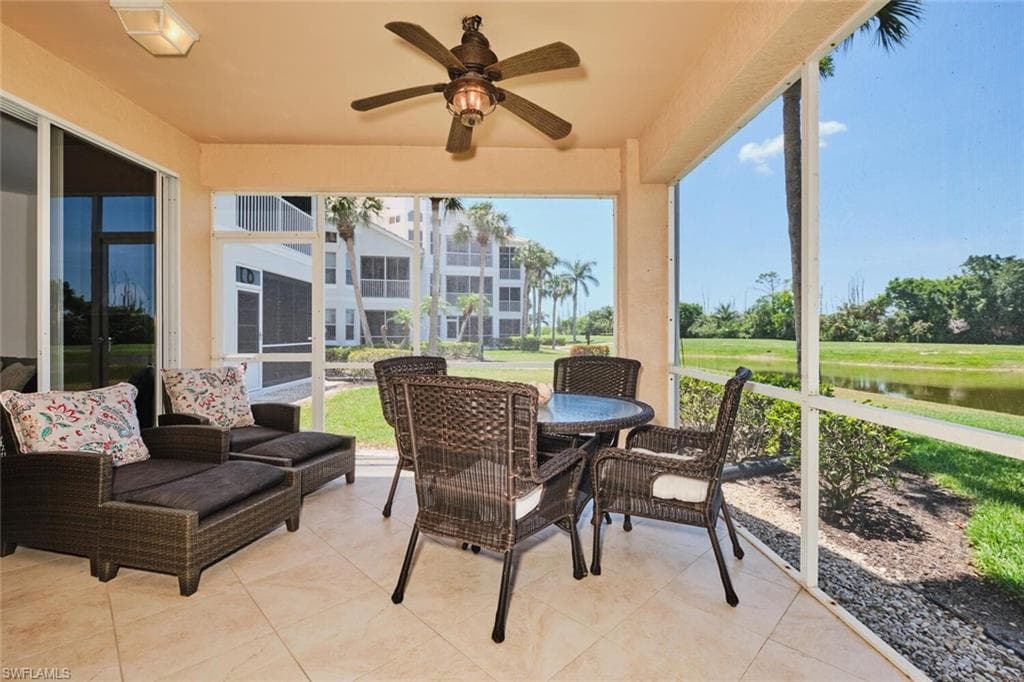Sunroom featuring a ceiling fan, a water view, and healthy amount of natural light
