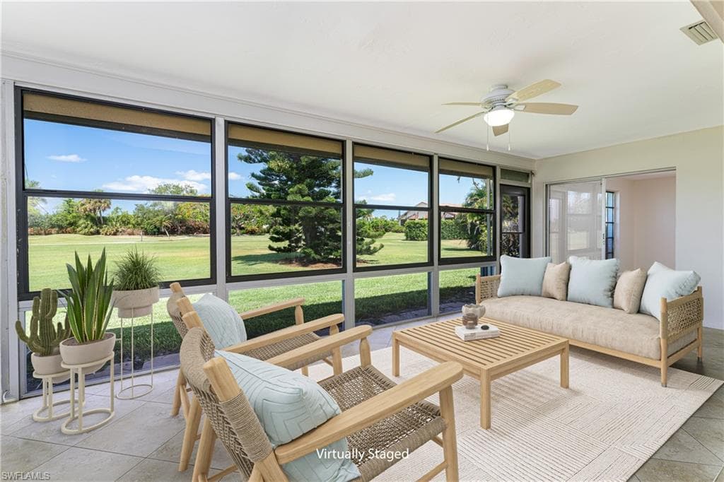 Large Indoor Lanai Living Space with view of Golf Course - Photo has been Virtually Staged
