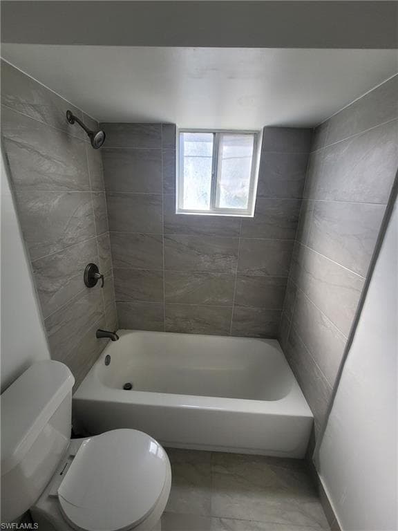 Bathroom with toilet and shower / bathtub combination