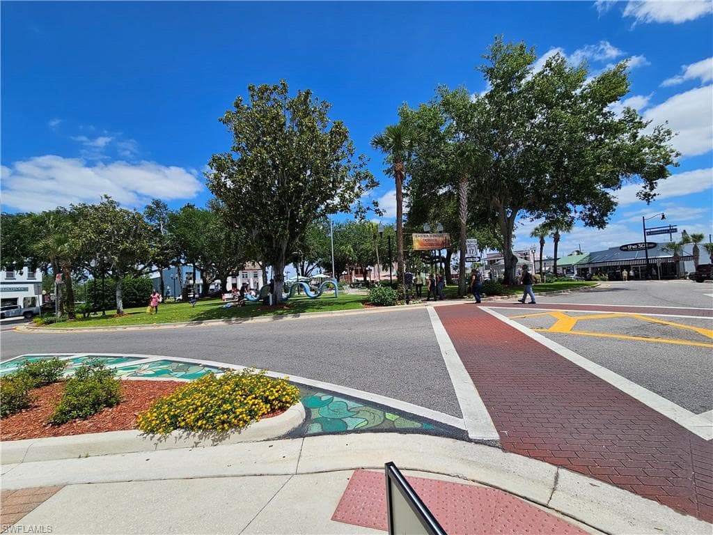 View of asphalt street with curbs and sidewalks