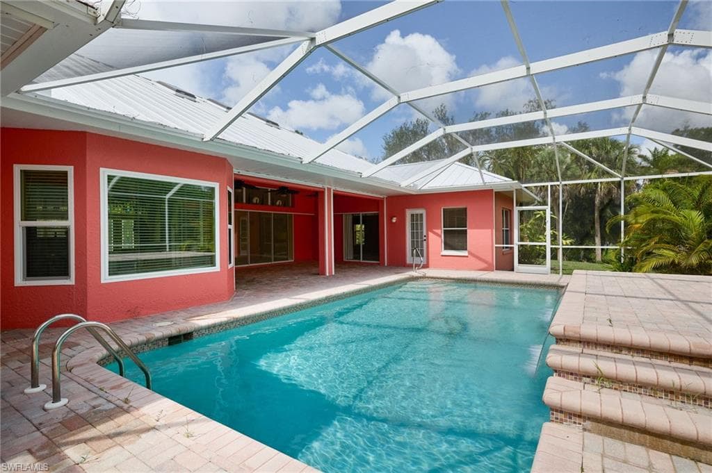 Swimming pool featuring a patio and a lanai