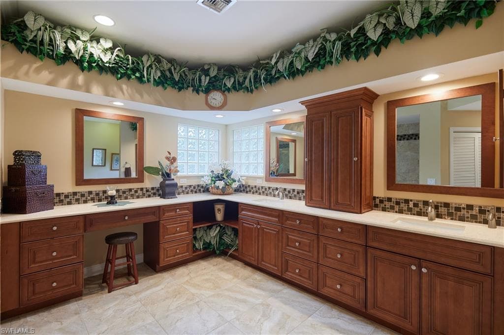 Full bathroom with tasteful backsplash, double vanity, and recessed lighting