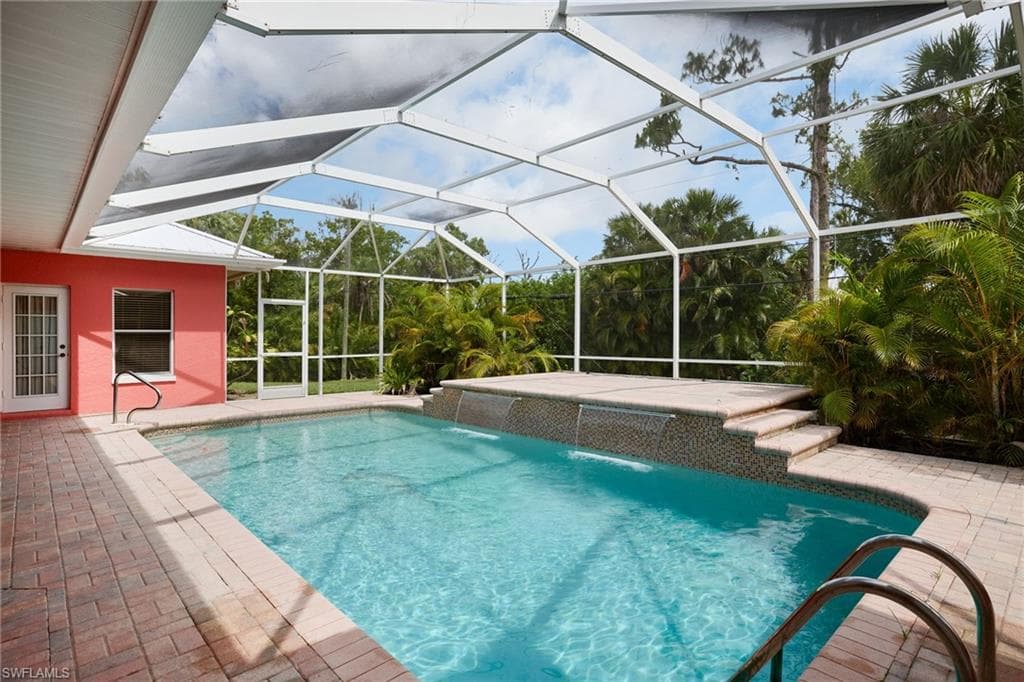 Outdoor pool featuring a patio area and a lanai