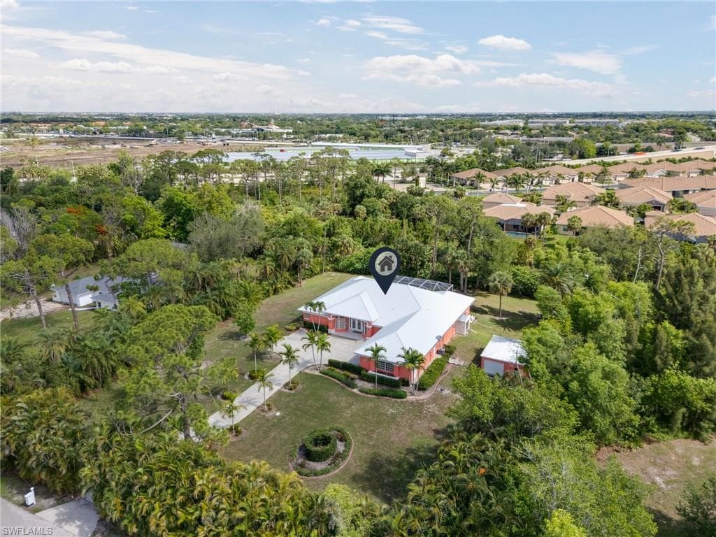 View from above of property with a tree filled landscape
