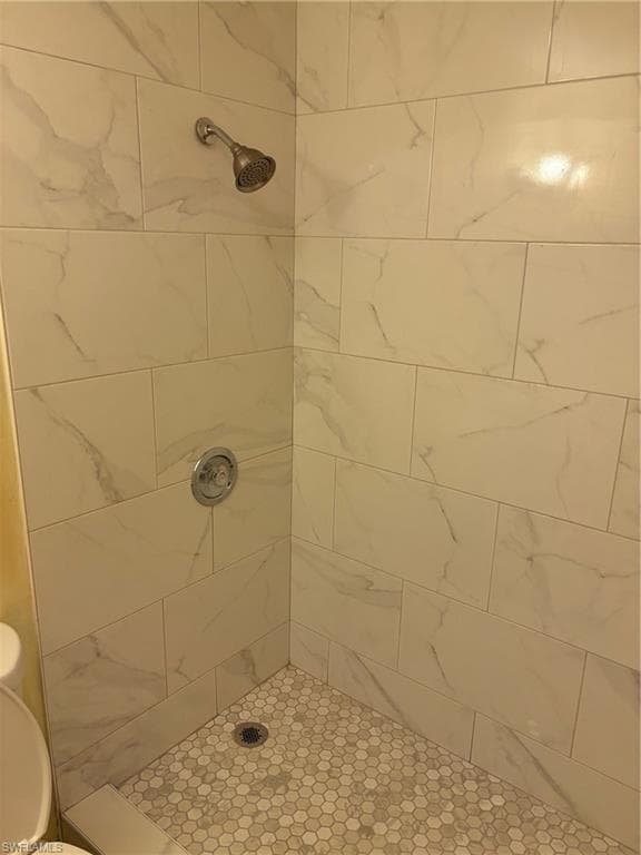 Bathroom featuring toilet and a tile shower