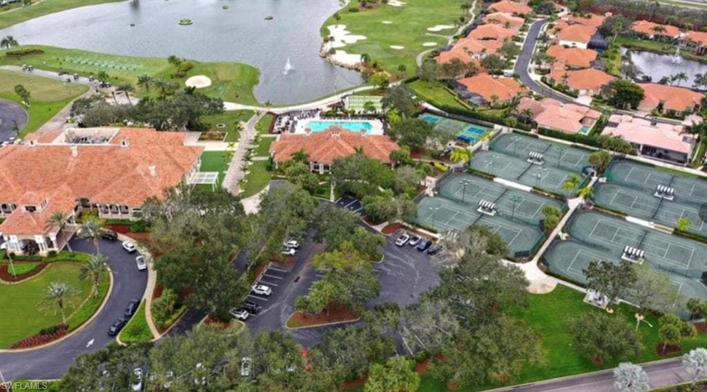 Aerial view of property and surrounding area with a local golf course and a large body of water