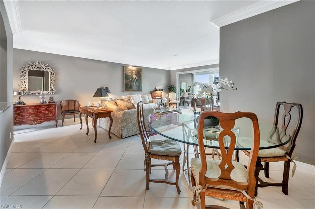 Dining room featuring ornamental molding and light tile patterned floors