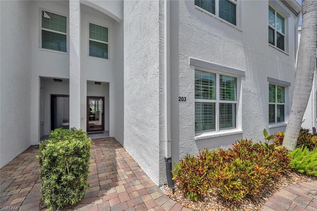 View of exterior entry with stucco siding