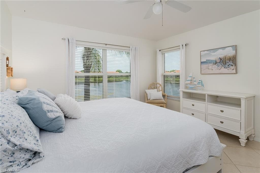 Bedroom featuring light tile patterned flooring and a ceiling fan