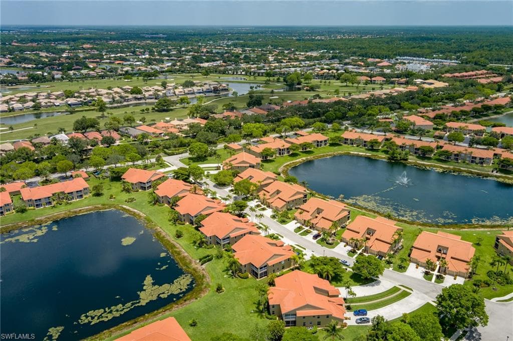 Aerial overview of property's location featuring a nearby body of water and nearby suburban area