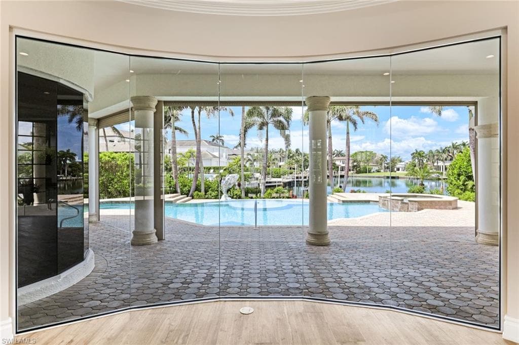 View of pool with a patio, a pool with connected hot tub, and a water view