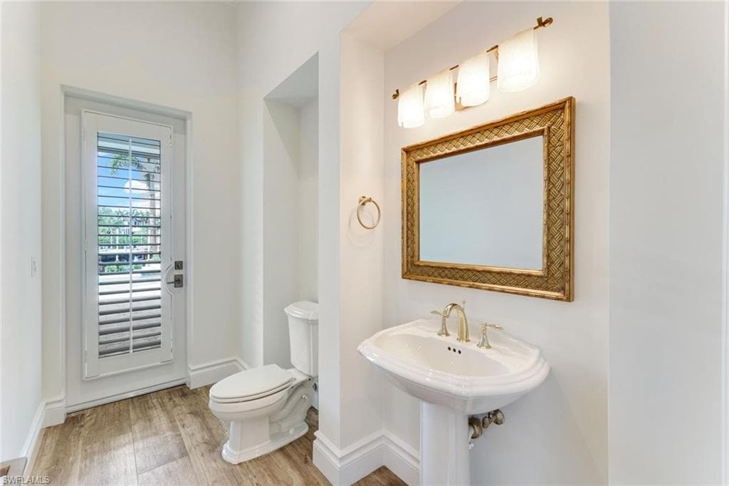 Downstairs powder room and pool bath opening up to pool area and summer kitchen.