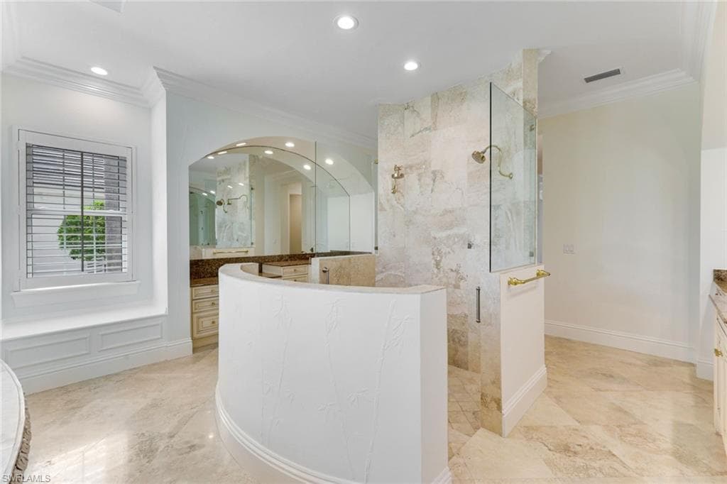 Master Bathroom featuring crown molding, vanity, a marble finish shower, recessed lighting, and marble finish flooring,private water closets with bidet.