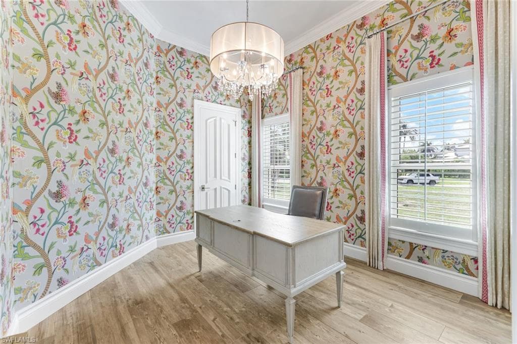 Downstairs Bedroom #2 wallpapered walls, light wood finished floors, a chandelier, crown molding, and plenty of natural light