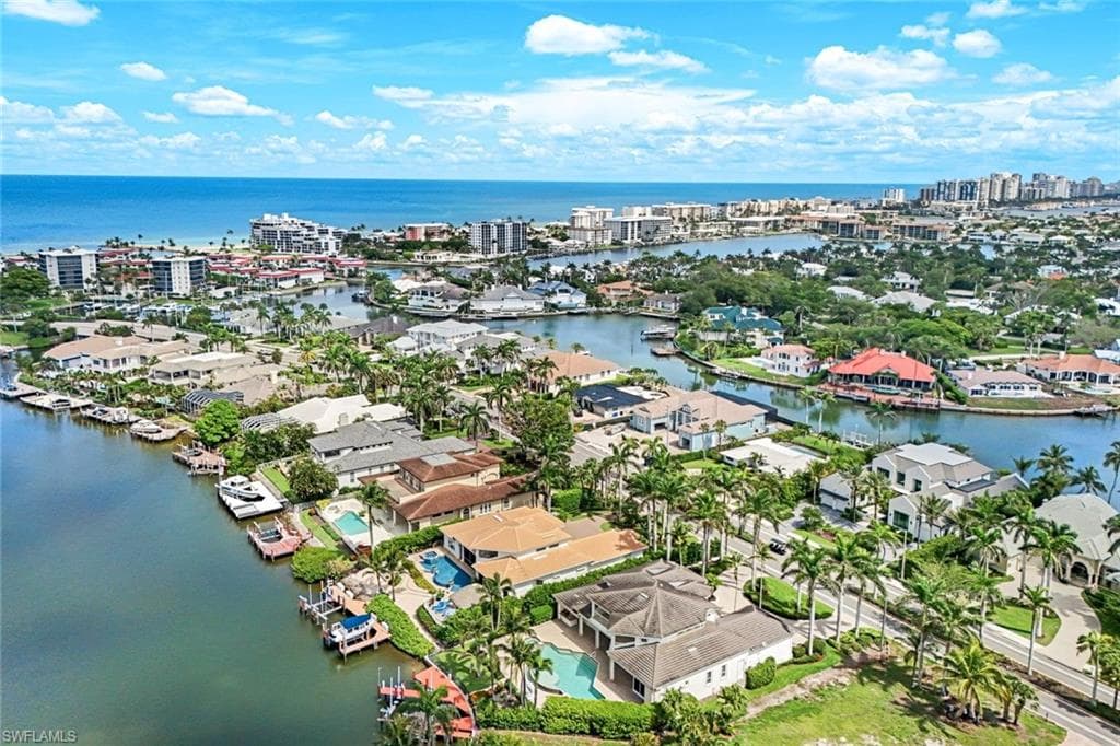 Aerial view of residential area featuring a nearby body of water