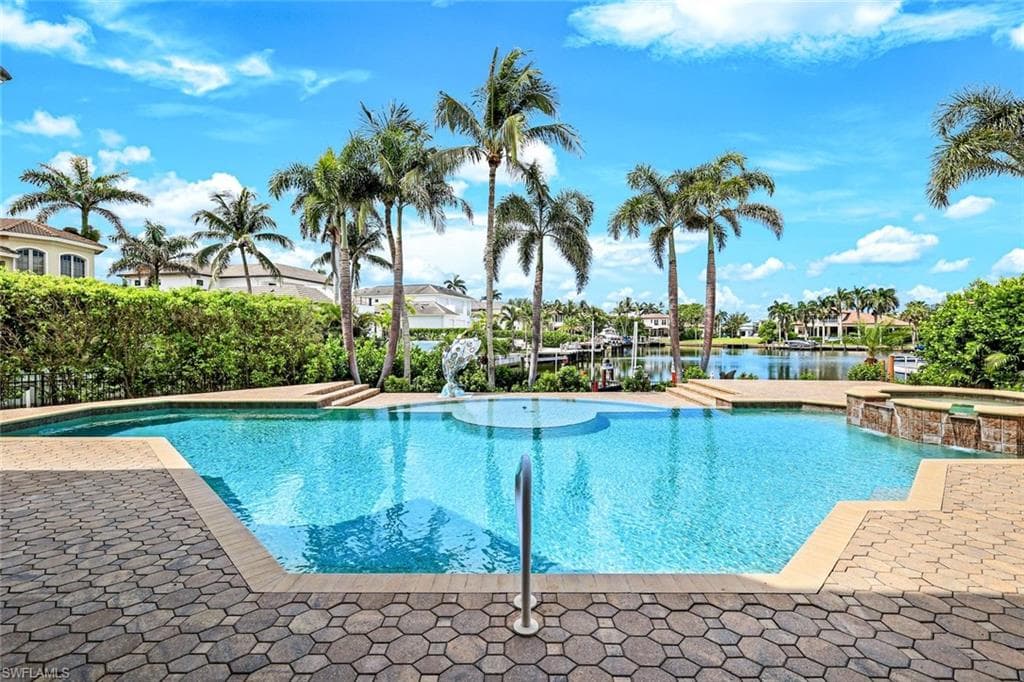 View of pool featuring a pool with connected hot tub and a patio
