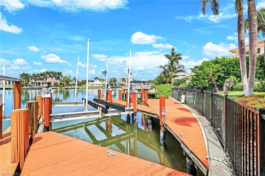 Dock with boat lift and a water view