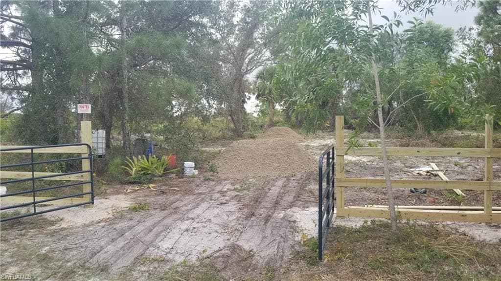 View of entrance gate and driveway fill at install