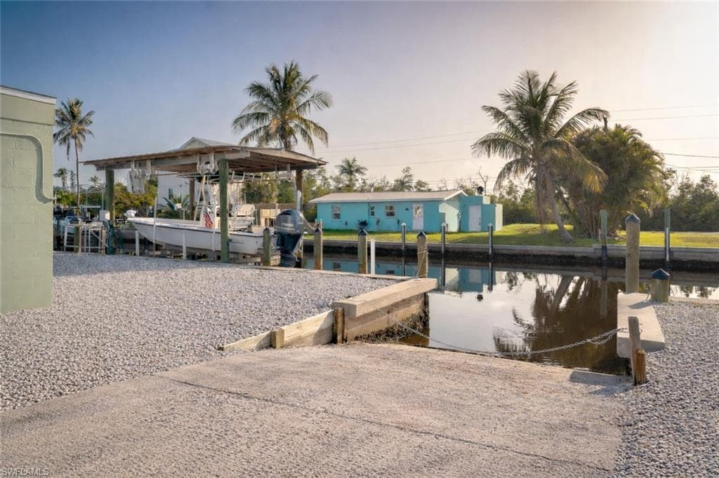 Dock area featuring a boat ramp and a water view