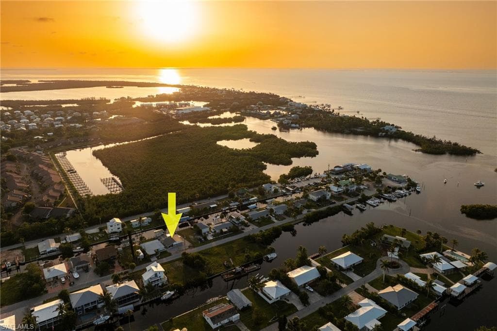 Aerial view at dusk of a water view and a residential view