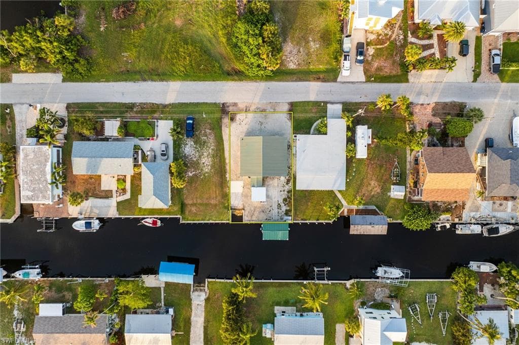 Aerial perspective of suburban area featuring a nearby body of water
