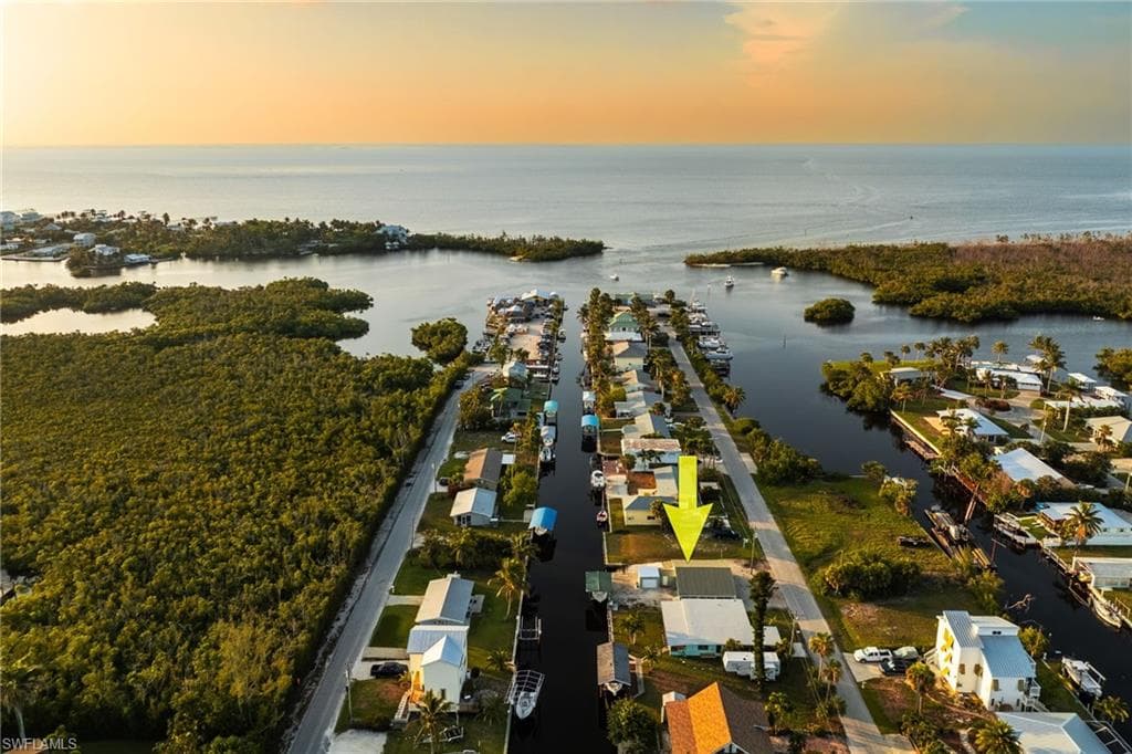 Aerial view of property and surrounding area with a nearby body of water